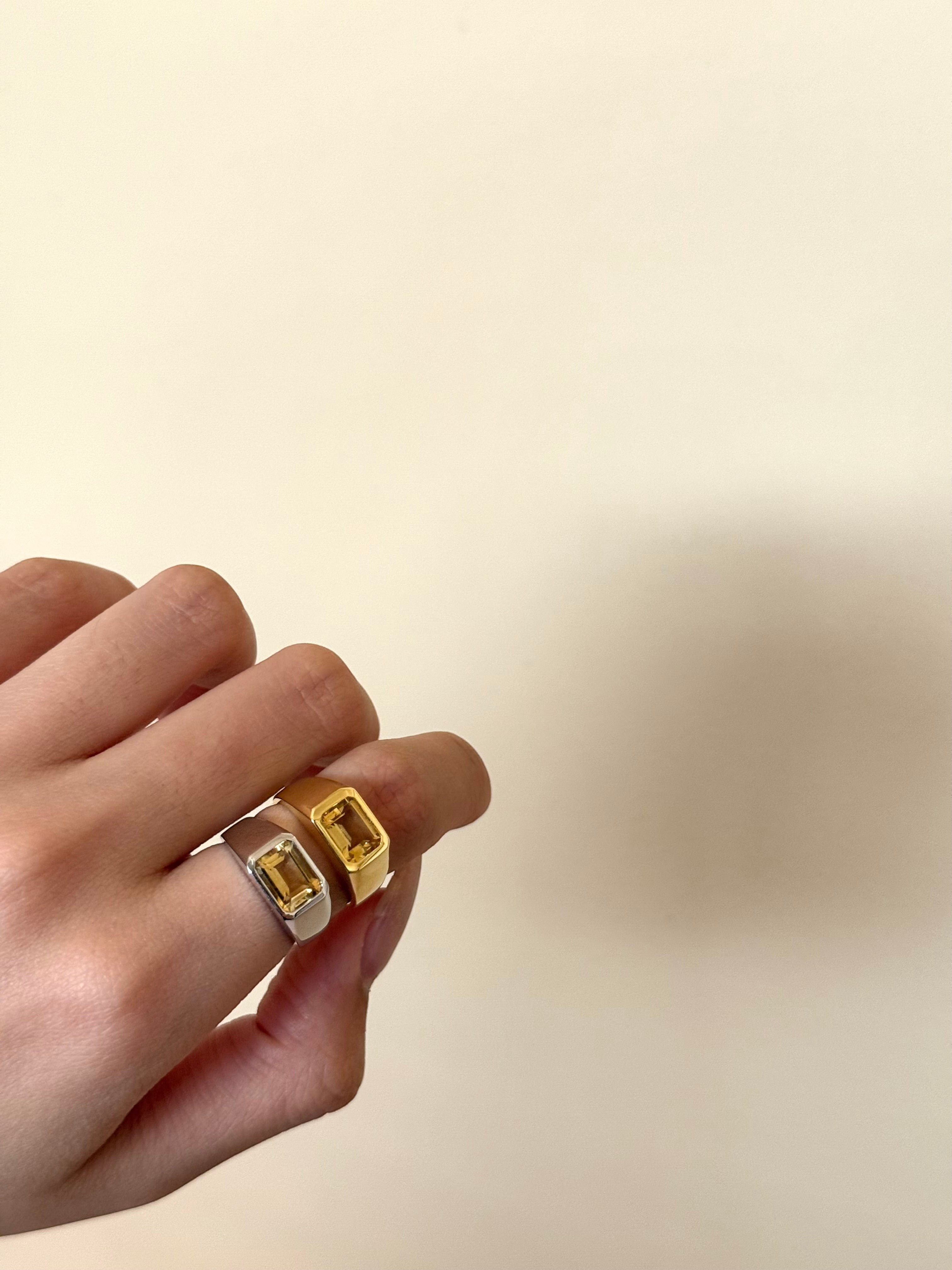 Bonté Asher ring in gold vermeil with a rectangular citrine gemstone. Silver ring also visible.